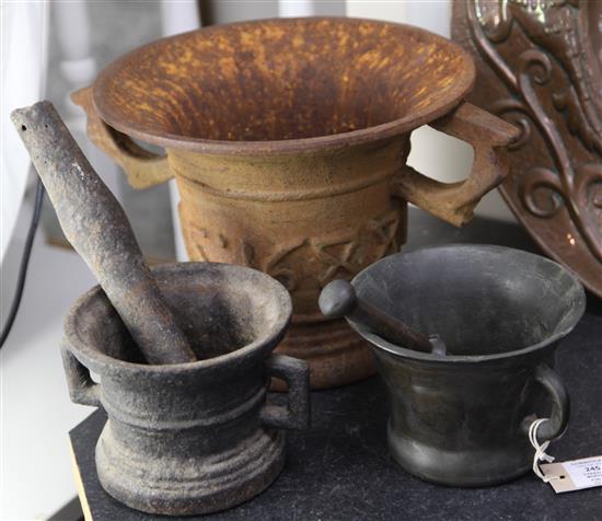 A large iron mortar with two lug handles and dated 1688,